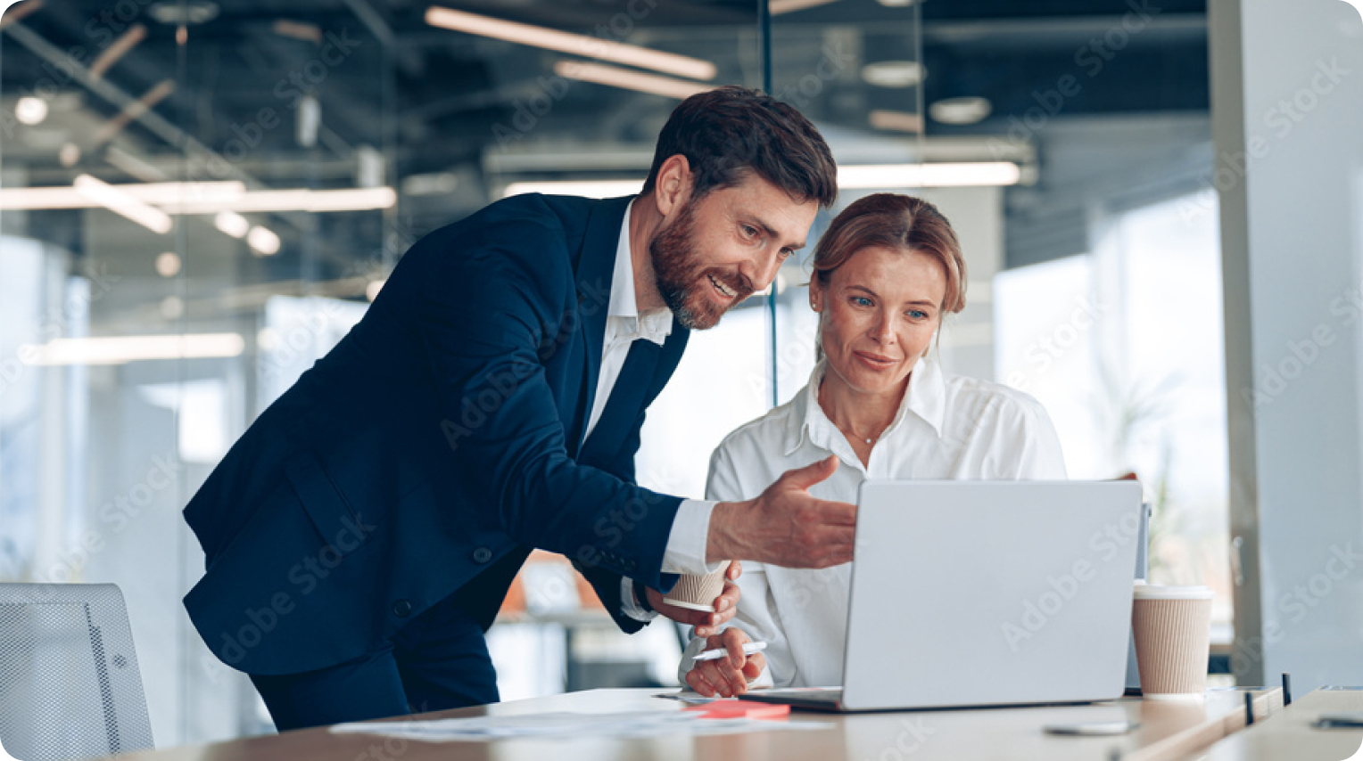 woman and man are looking at laptop